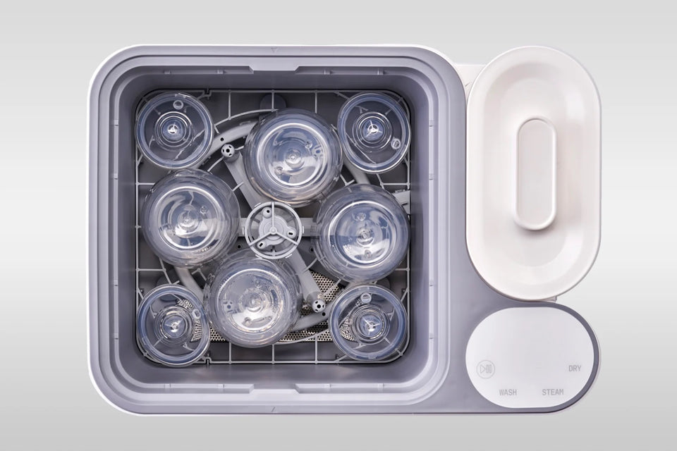 A loaded rack of bottles in the nuviebaby Clean Max, open basin.