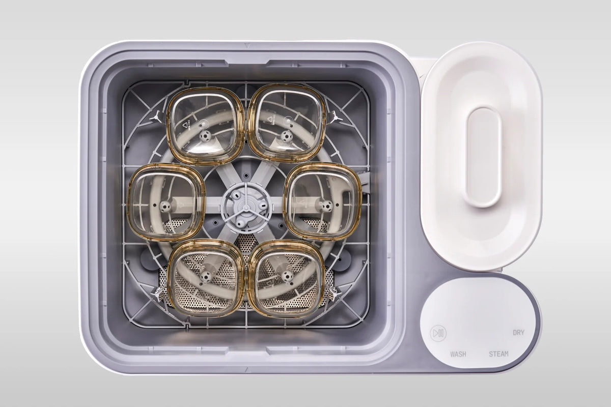 Six Hegen bottles loaded in the nuviebaby Clean Max washing basin, seen from above.
