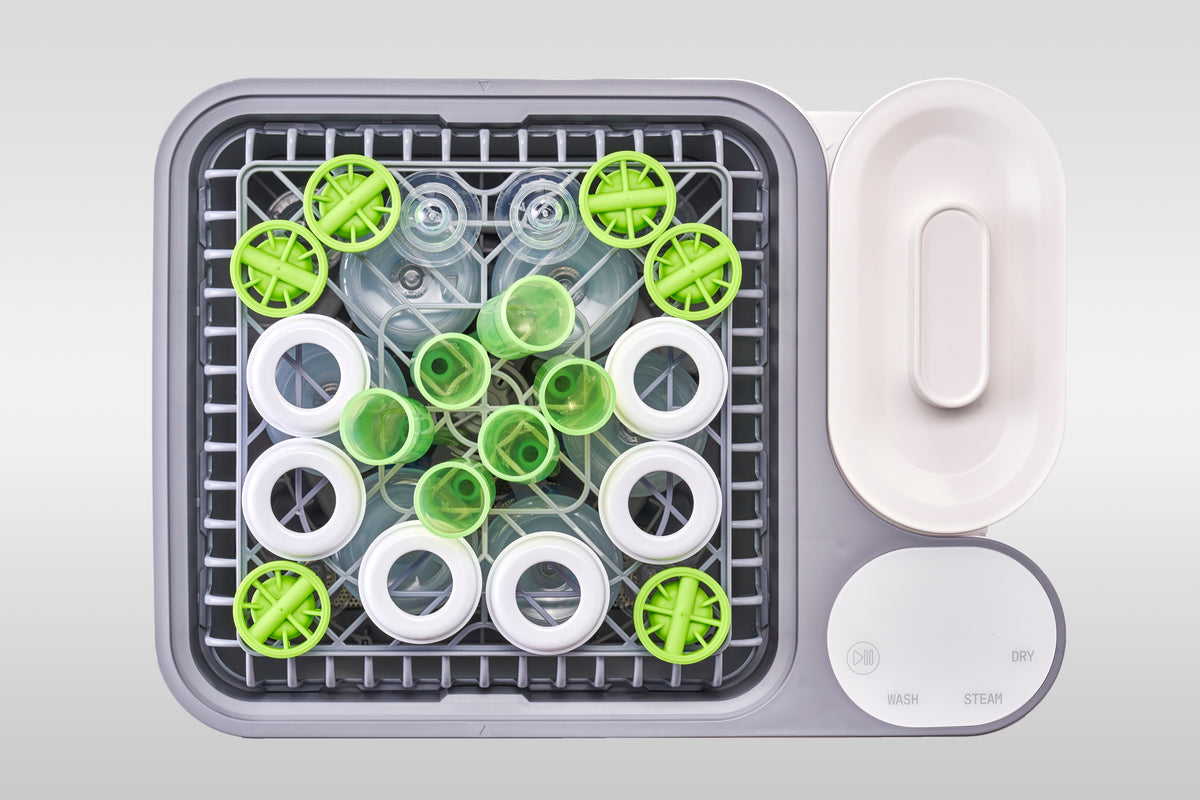 Six Dr. Brown's Anti-Colic bottles loaded in the nuviebaby Clean Max washing basin, seen from above.