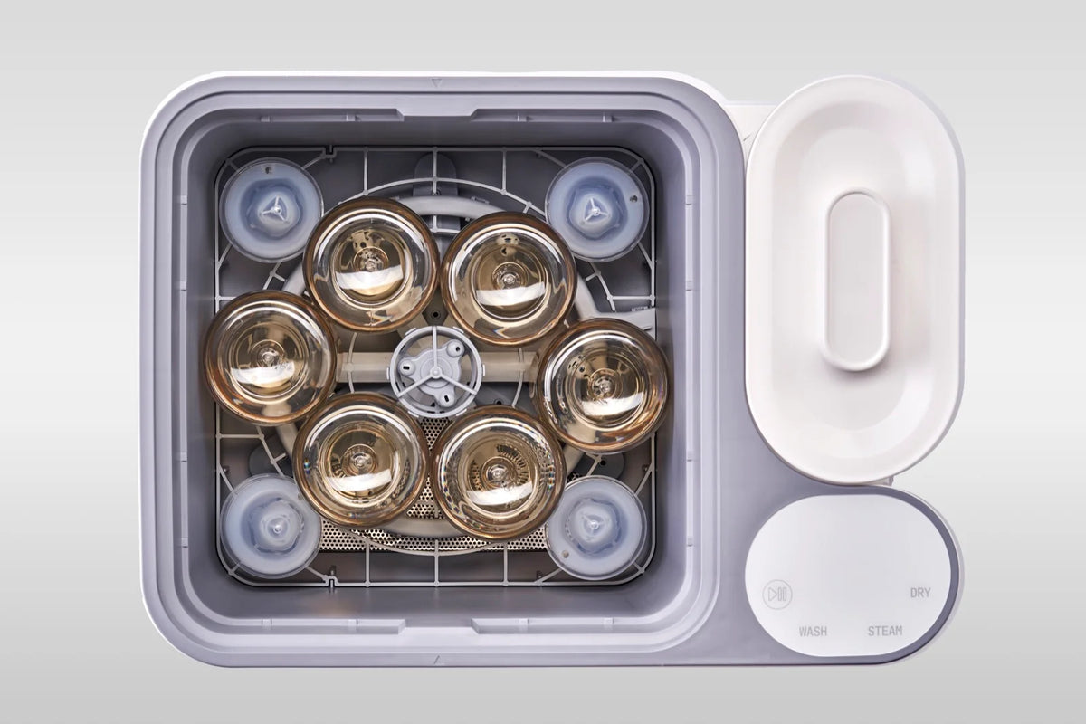 Six Pigeon bottles loaded in the nuviebaby Clean Max washing basin, seen from above.